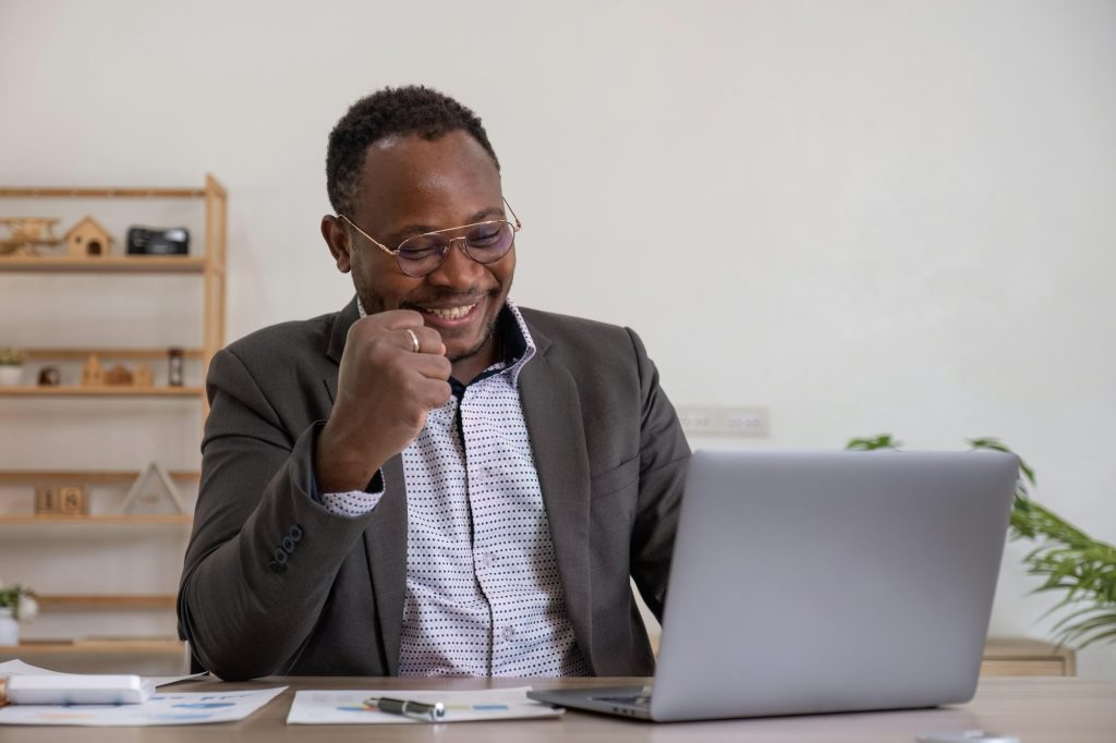 Portrait of happy business African American man celebrating success achievement. positive